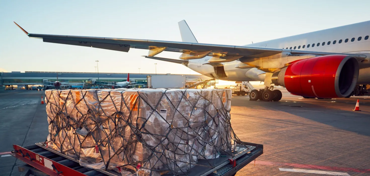 Airplane cargo on the runfield during sunset